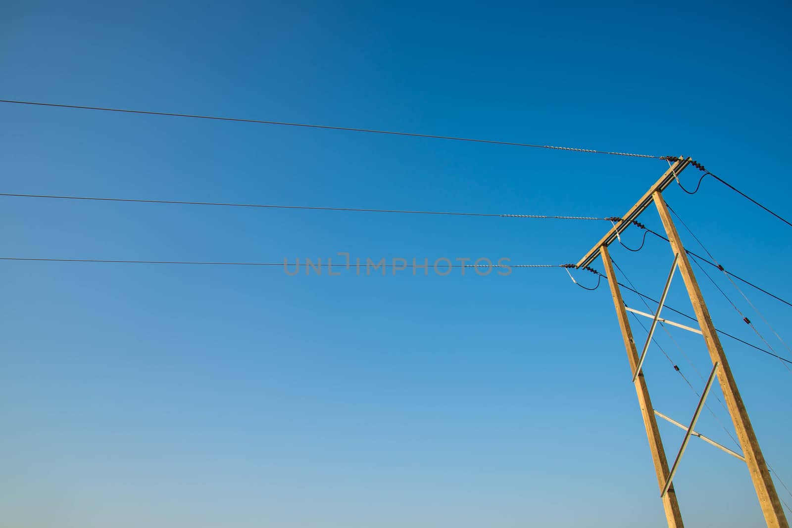 Electricity post and a blue sky background.