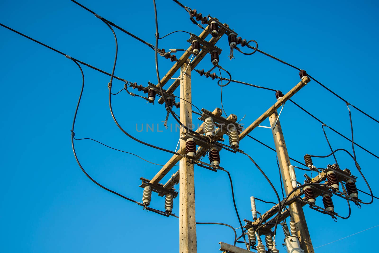 Electricity post and a blue sky background.