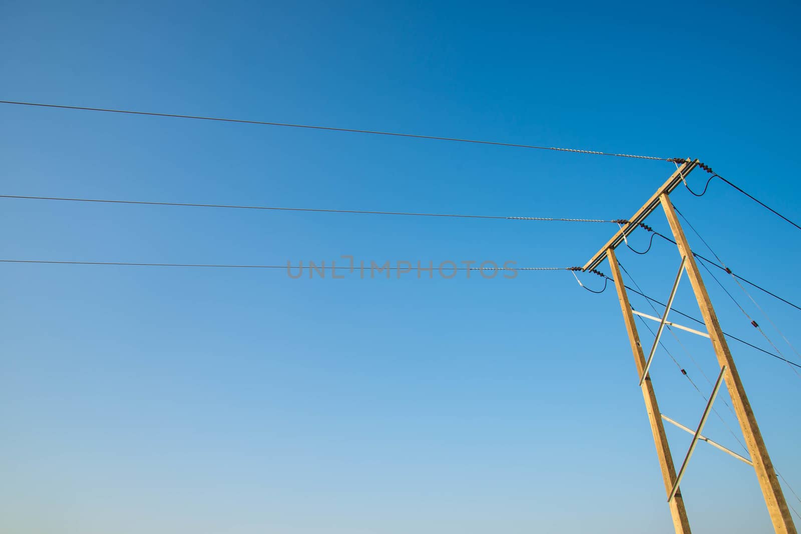 Electricity post and a blue sky background.