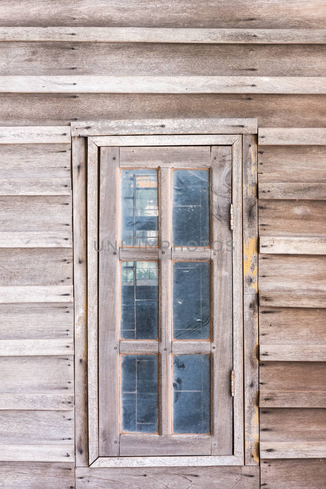 Old window in wooden cottage, classic house