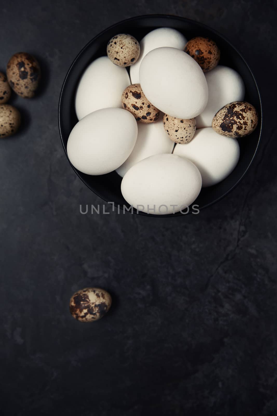 Quail and chicken eggs on a table by Novic