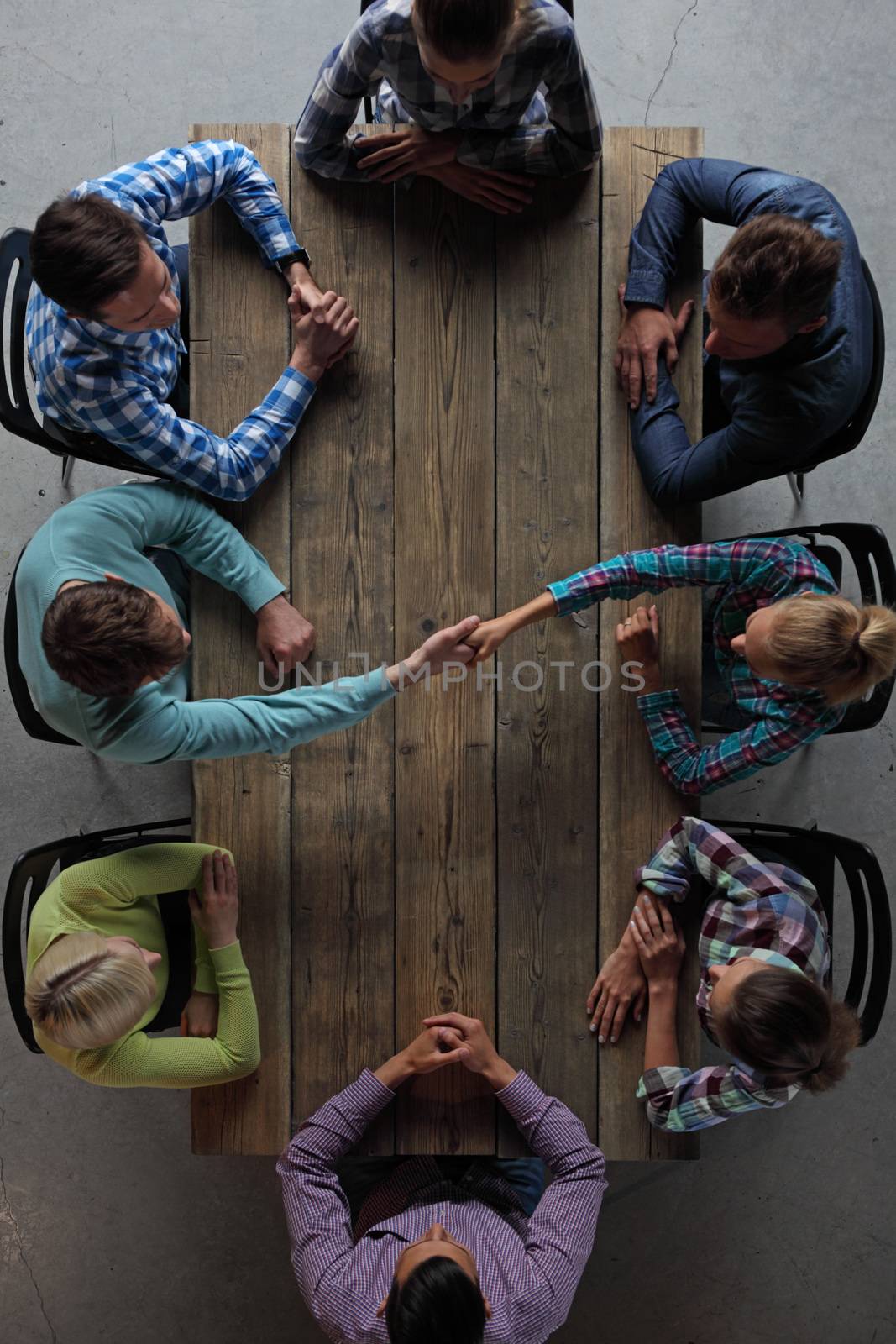 Hipster business people shaking hands by ALotOfPeople