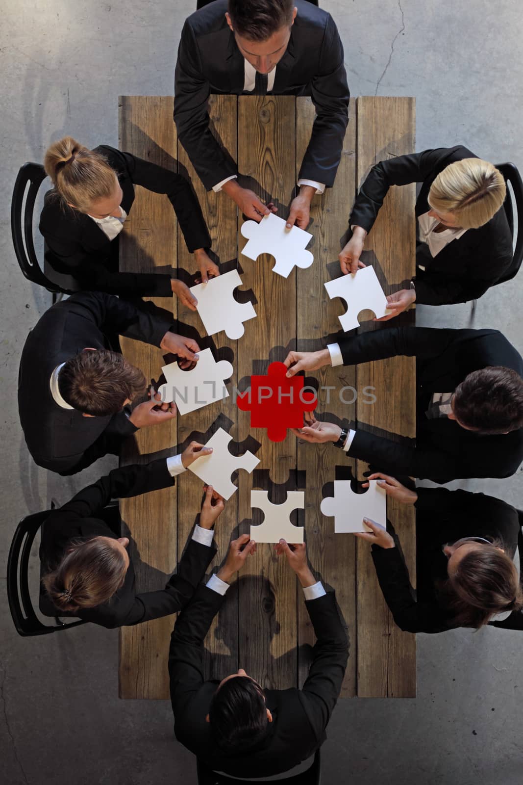 Business people and puzzle by ALotOfPeople
