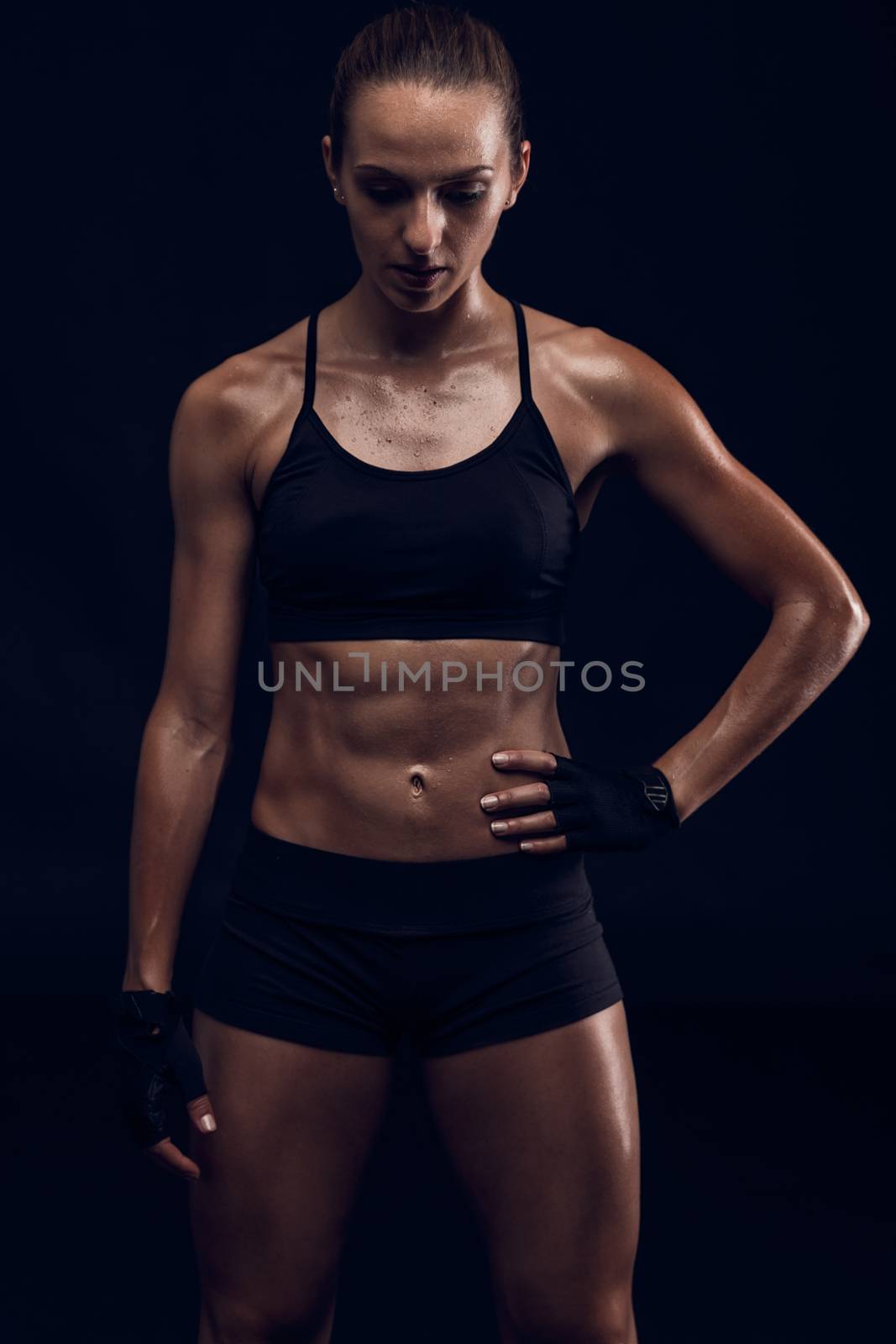 Studio portrait of a sporty young woman posing against a dark background
