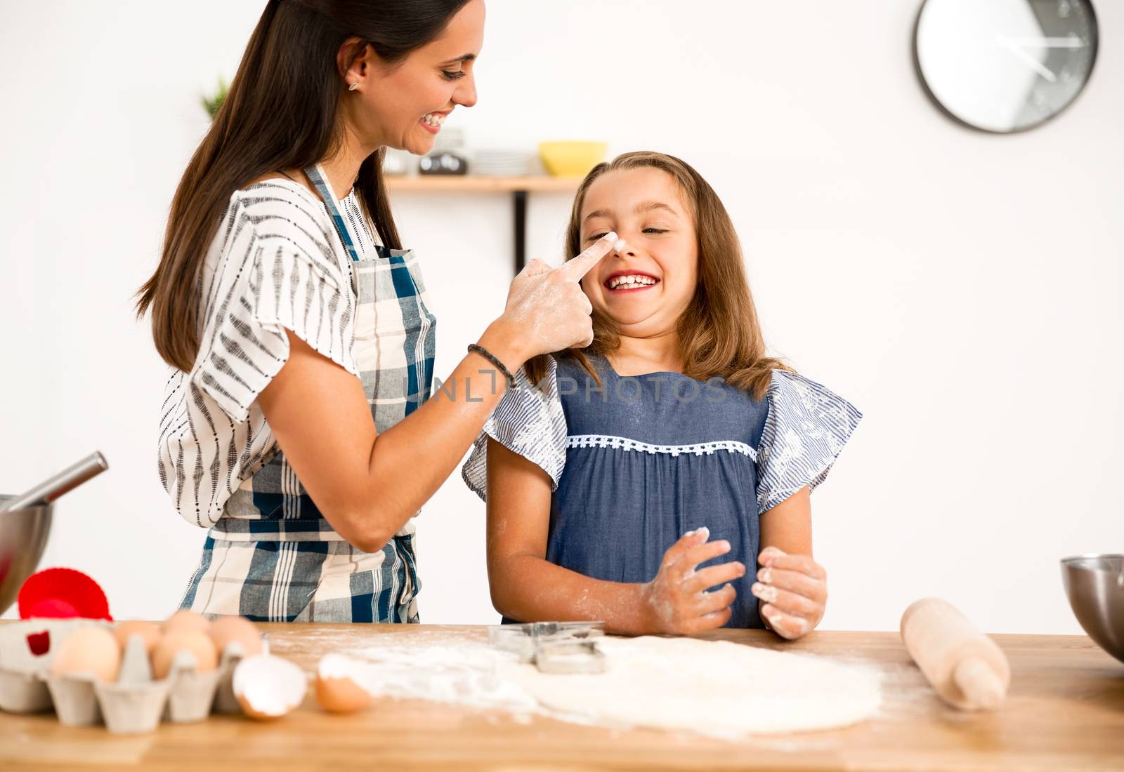 Shot of a mother and daughter having fun in the kitchen and learning to make a cake