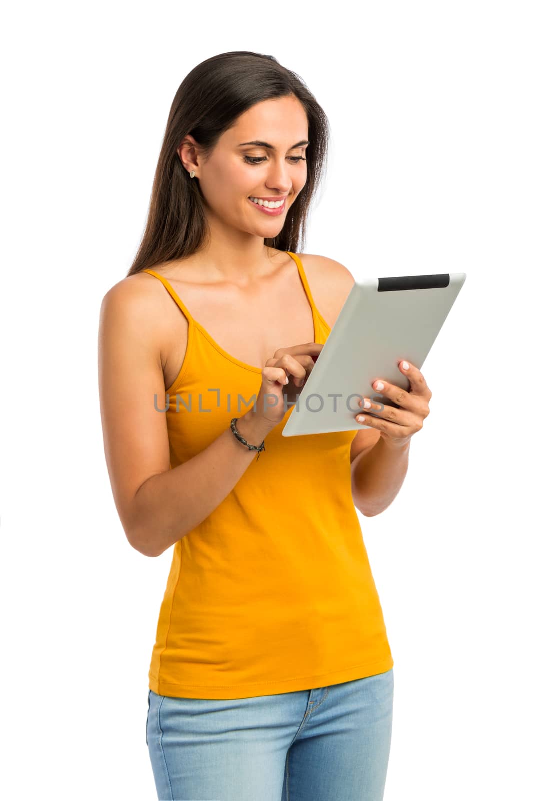 Beautiful and happy young woman working with a tablet