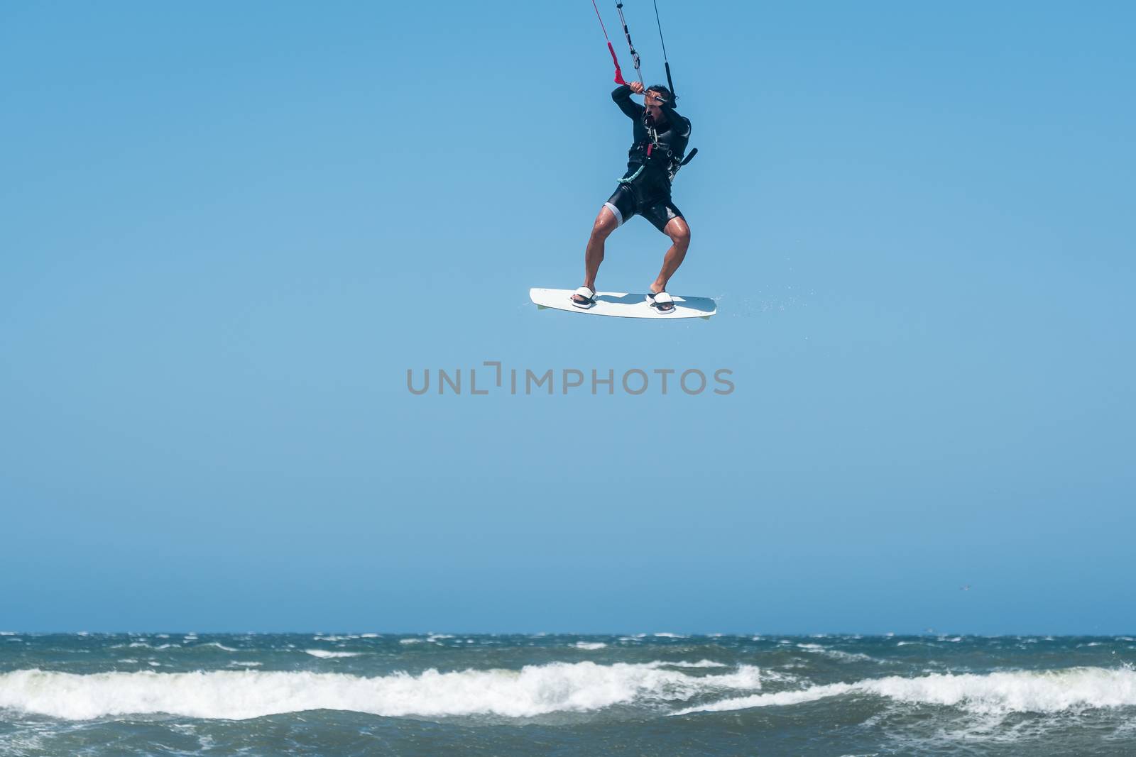Kiteboarder enjoy surfing on a sunny day.