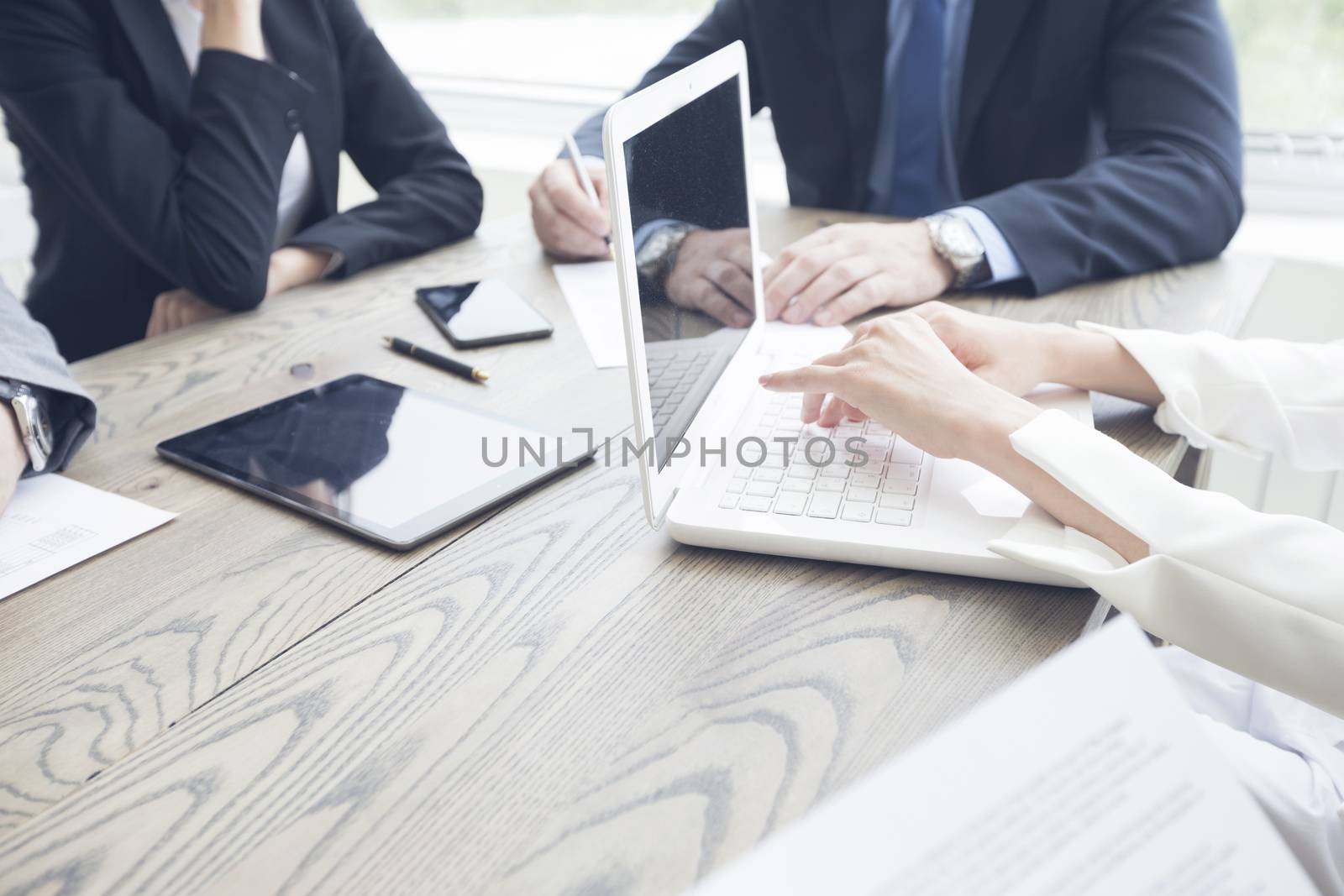 Business people work with documents and computers at office table close up