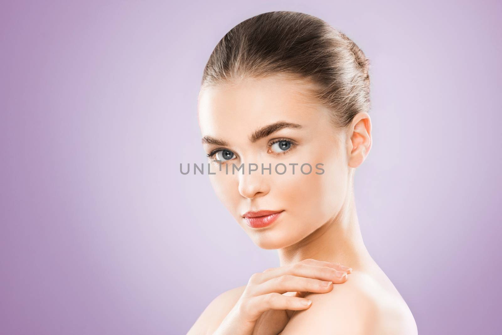 Beauty woman face portrait. Beautiful model girl with perfect fresh clean skin. Female looking at camera. Youth and skin care Concept