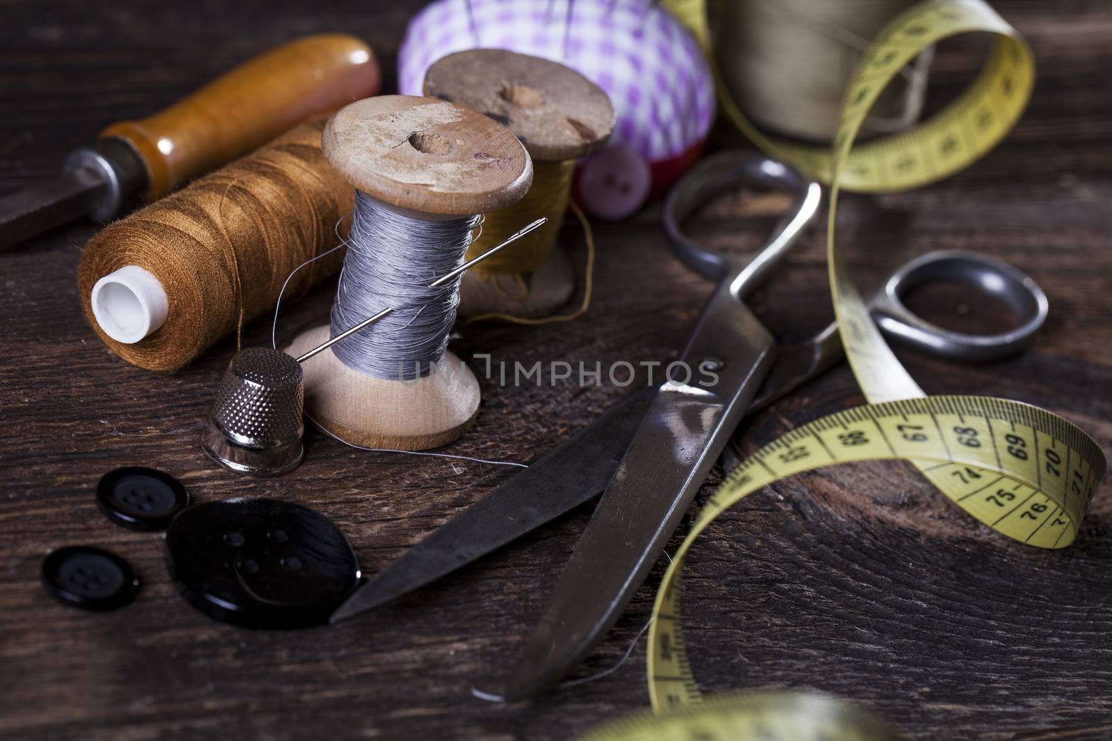 Sewing instruments, threads, needles, bobbins and materials. Studio photo
