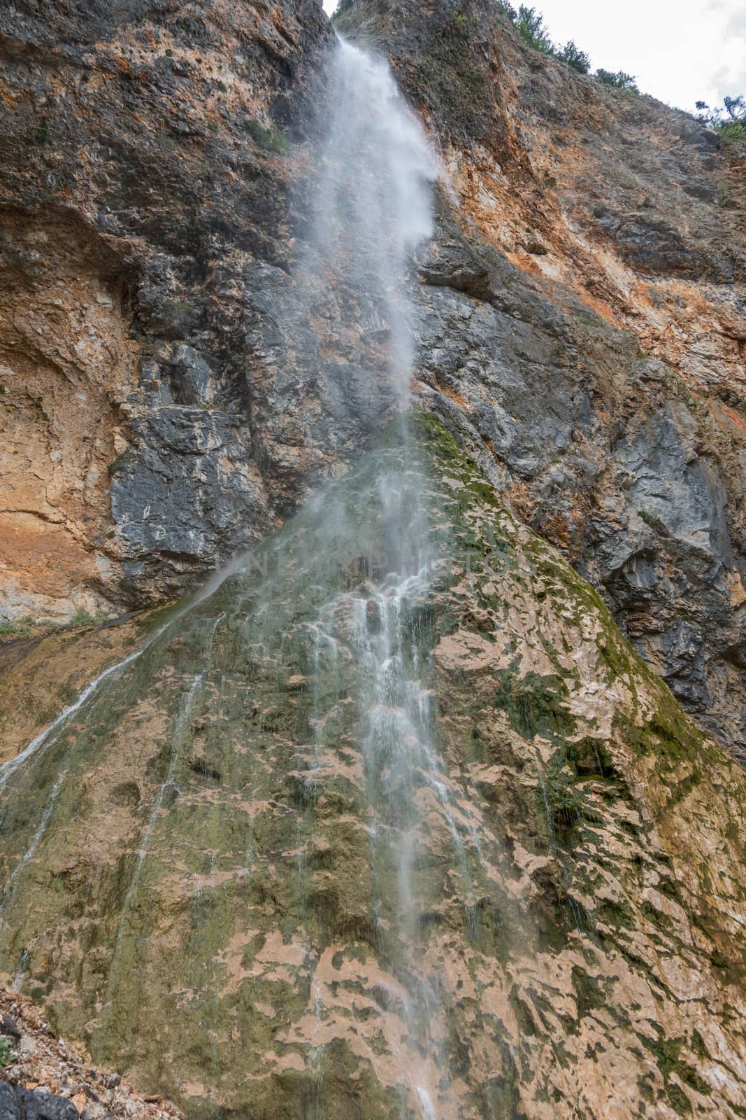 Rinka waterfall in beautiful Alpine valley, Logarska dolina - Logar valley in Slovenia. It's a popular tourist hiking destination in pristine nature surrounded by mountains