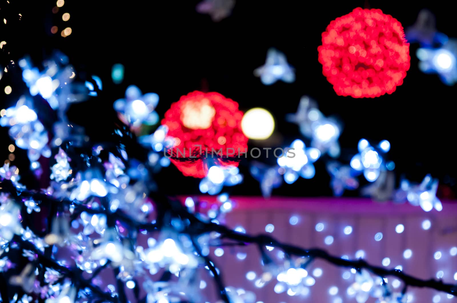 blury red light balls and white lights in forground