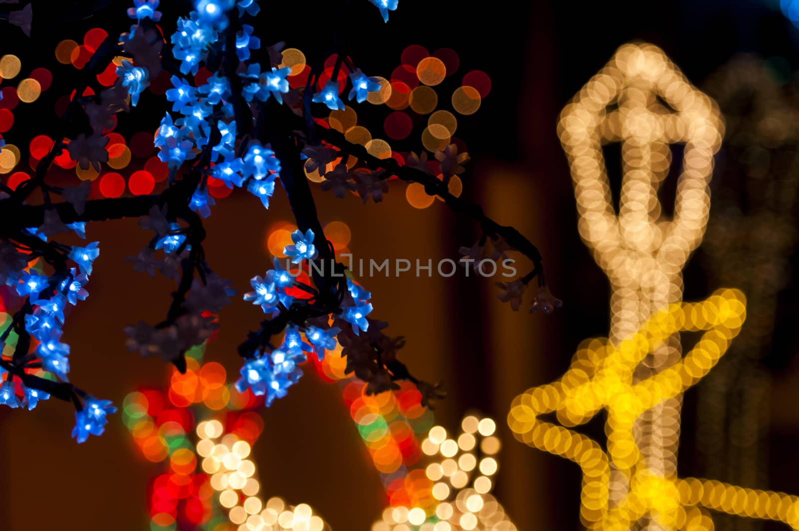 Blury white and yellow lights with red and blue lights  behind