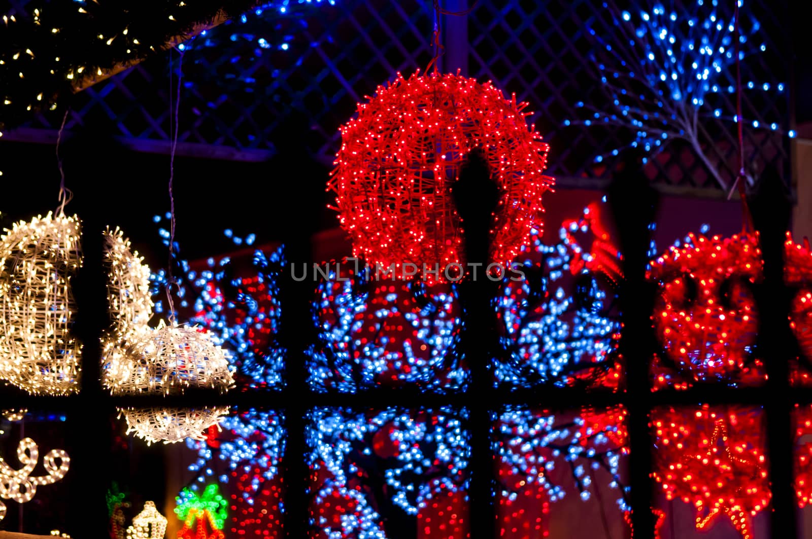 red light ball behind iron railings by vangelis