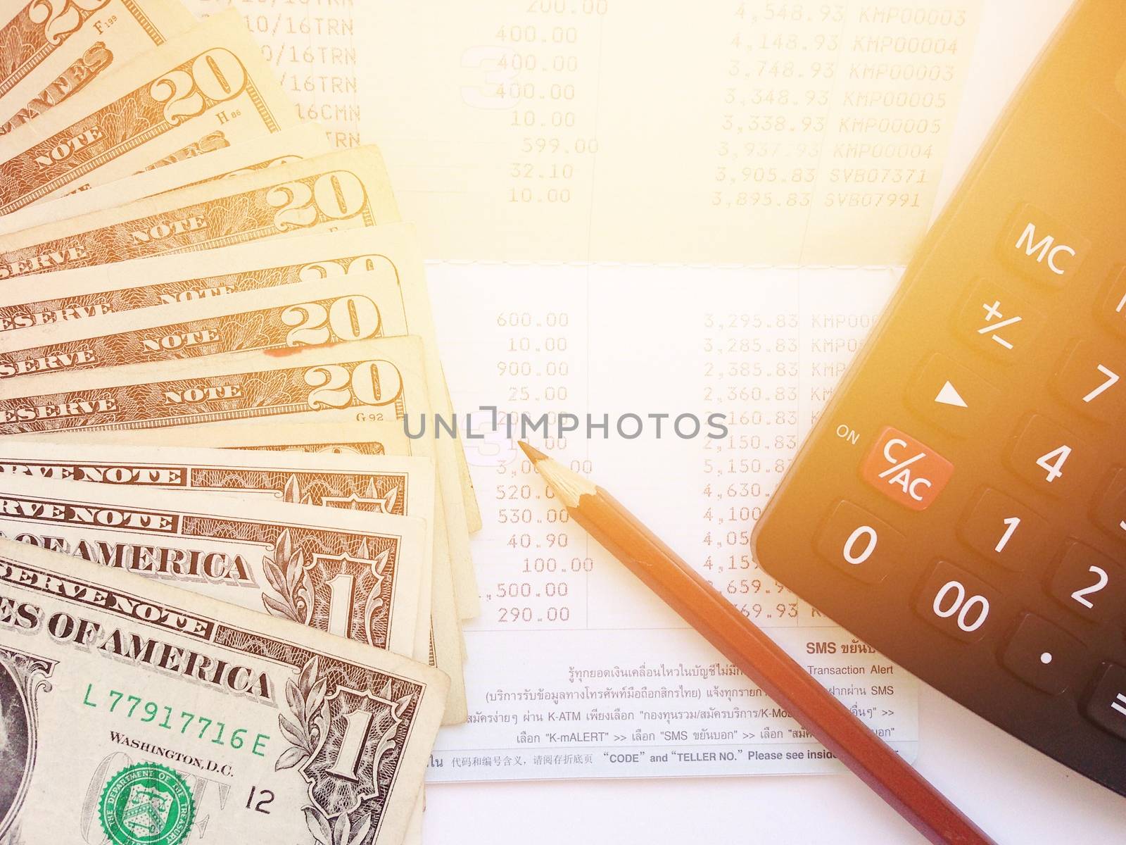 Business, finance, savings, banking or loan concept : Pencil, calculator, money and savings account passbook or financial statement on white background