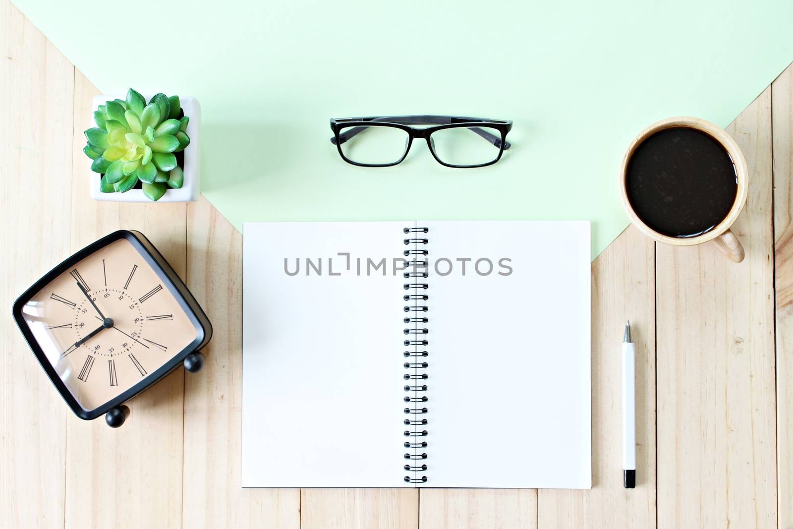 Still life, business, office supplies or education concept : Top view image of open notebook paper with blank pages, accessories and coffee cup on wooden background, ready for adding or mock up