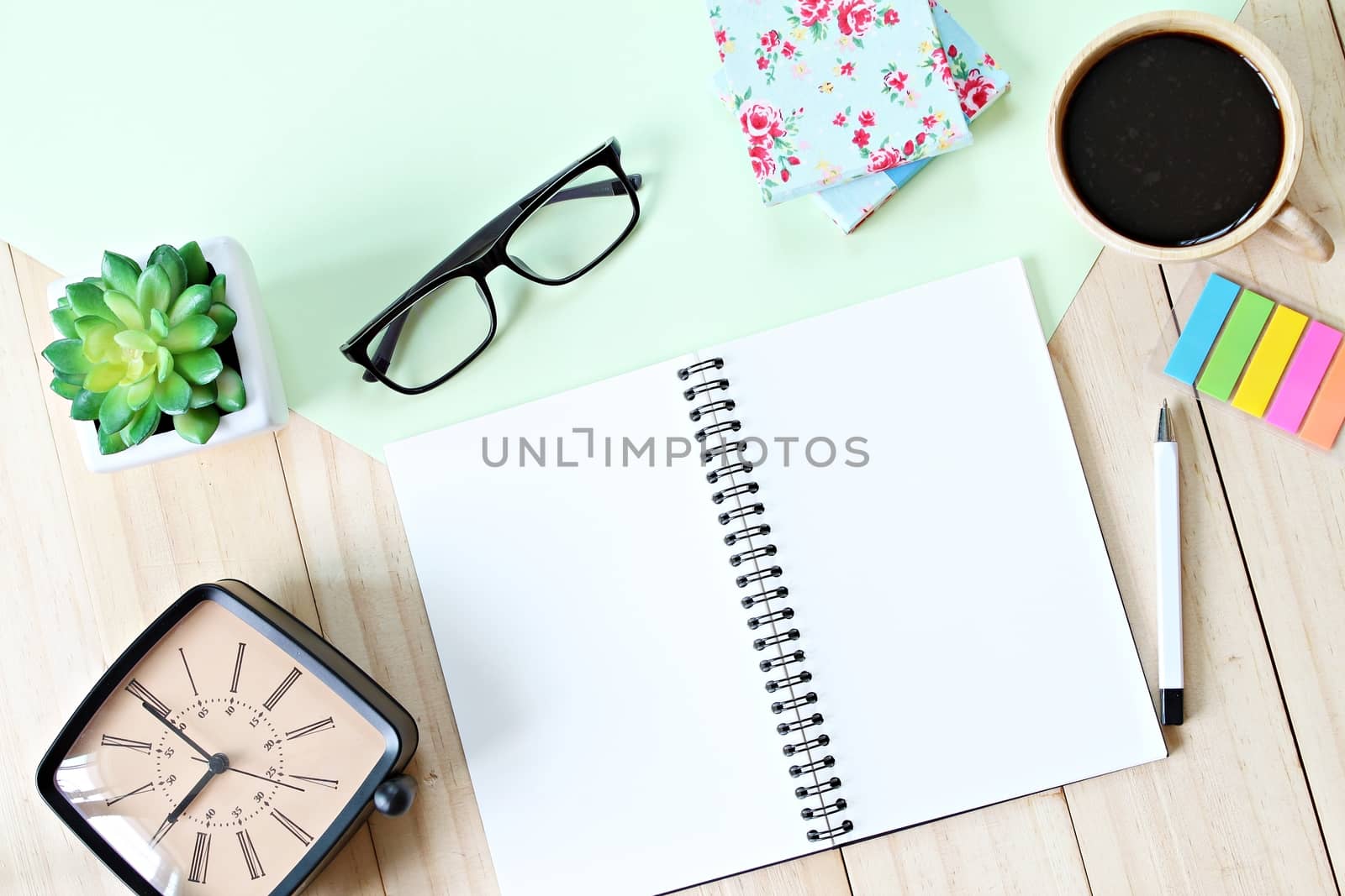 Still life, business, planning or education concept : Office desk table with open notebook paper, accessories and coffee cup, Top view or flat lay with copy space ready for adding or mock up