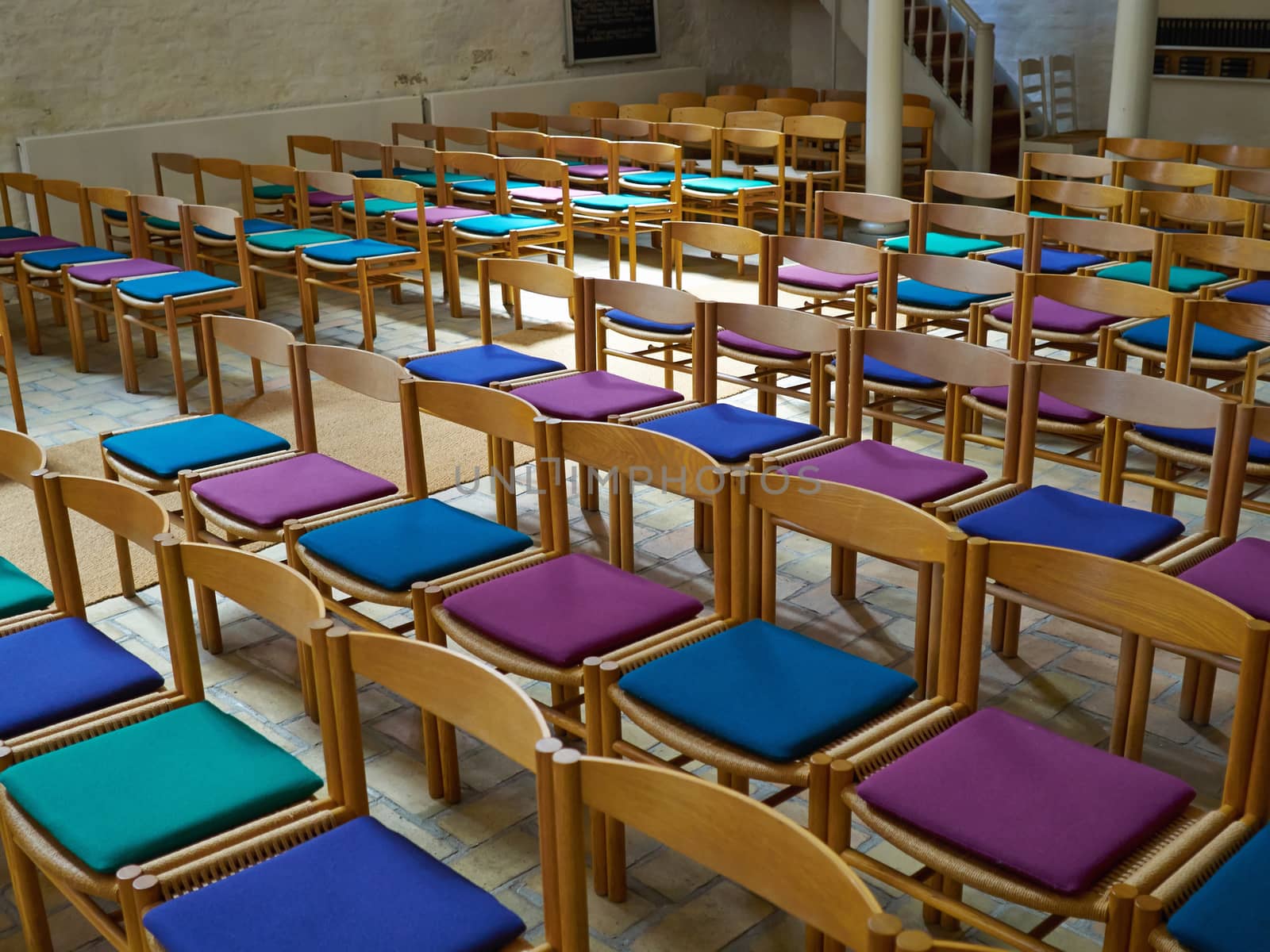 Simple wooden chairs in a church by Ronyzmbow