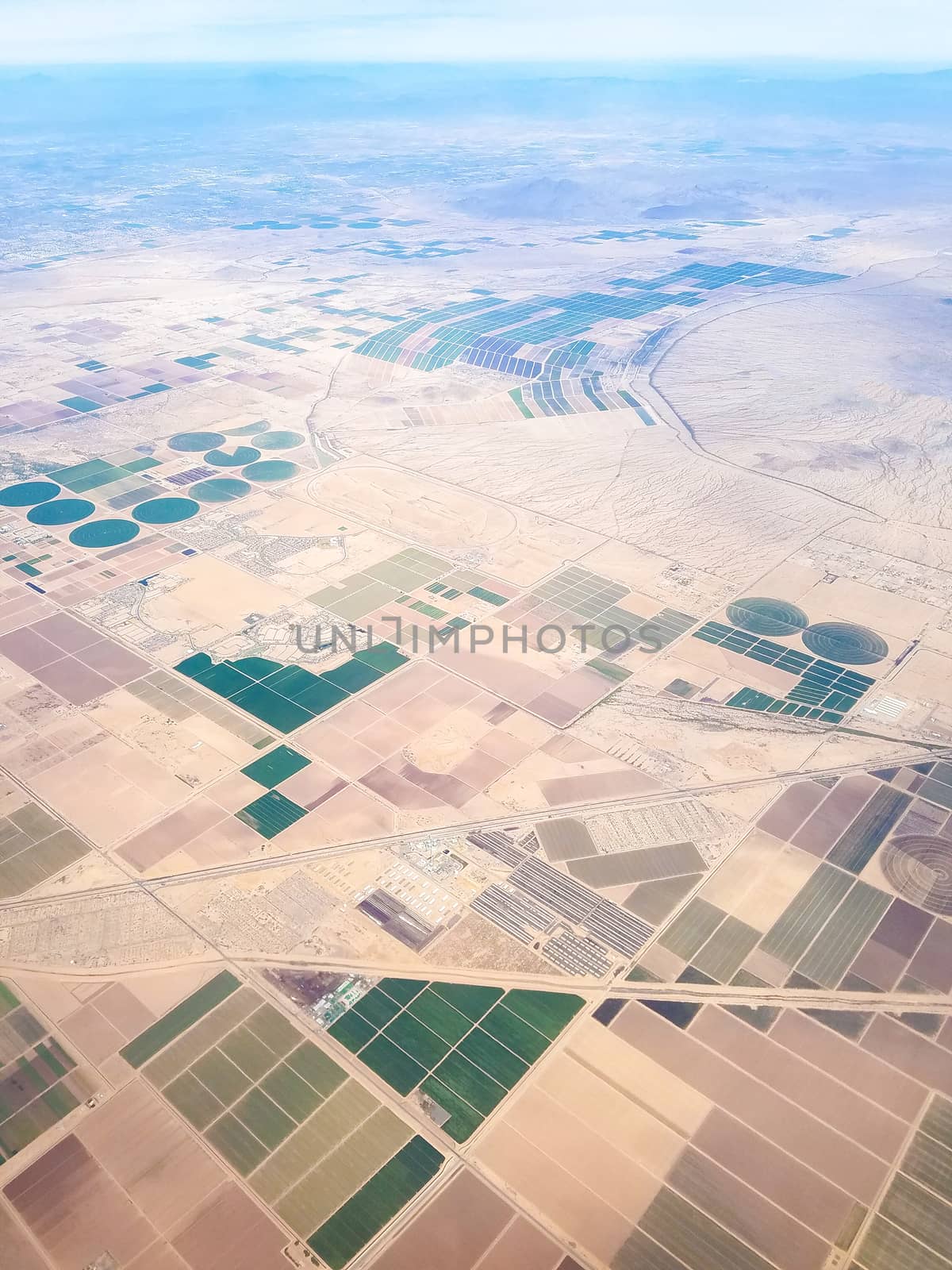 Fields of Arizona, USA, seen from above, with a few neighborhoods in the city of Maricopa.