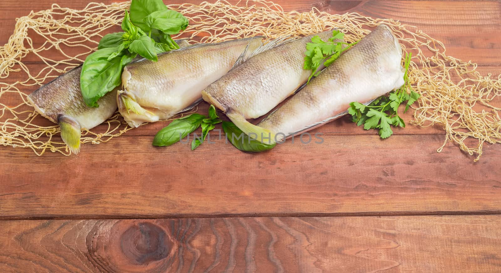 Several carcasses of the notothenia fish on a wooden surface by anmbph