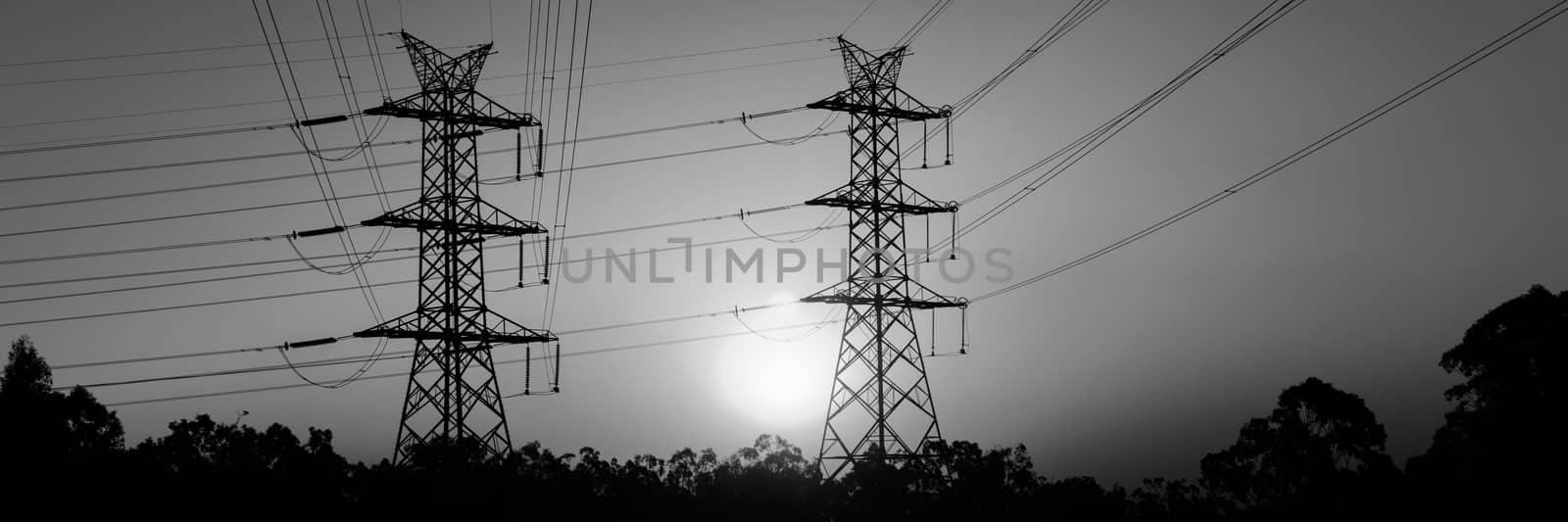 High voltage power tower at sunset by artistrobd