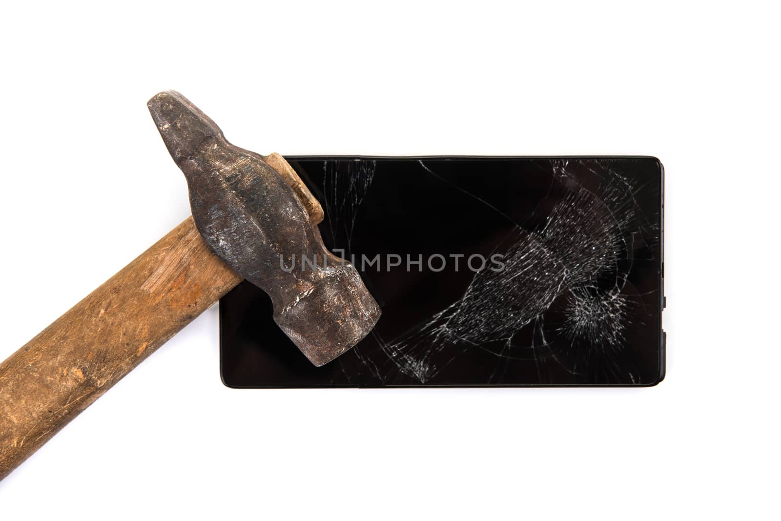 An old hammer and smartphone with broken screen on a white background