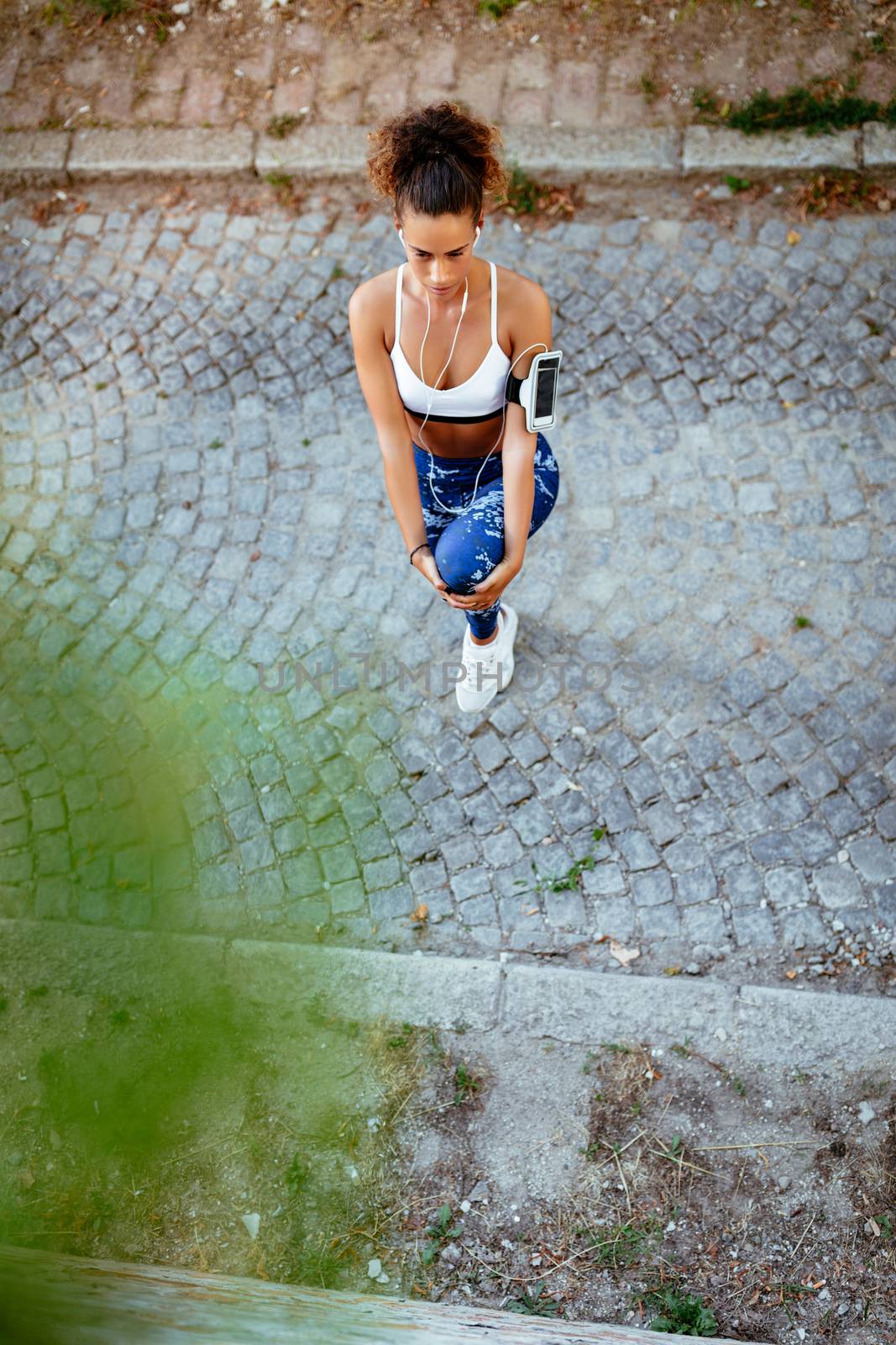 Urban Runner Girl Stretching by MilanMarkovic78