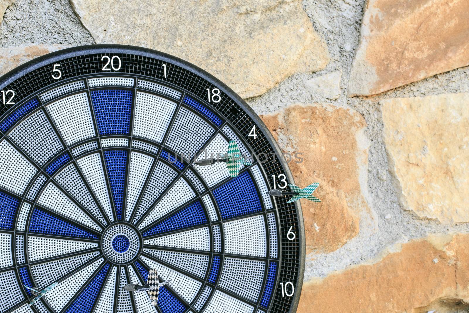 Bullseye on a wall with some darts