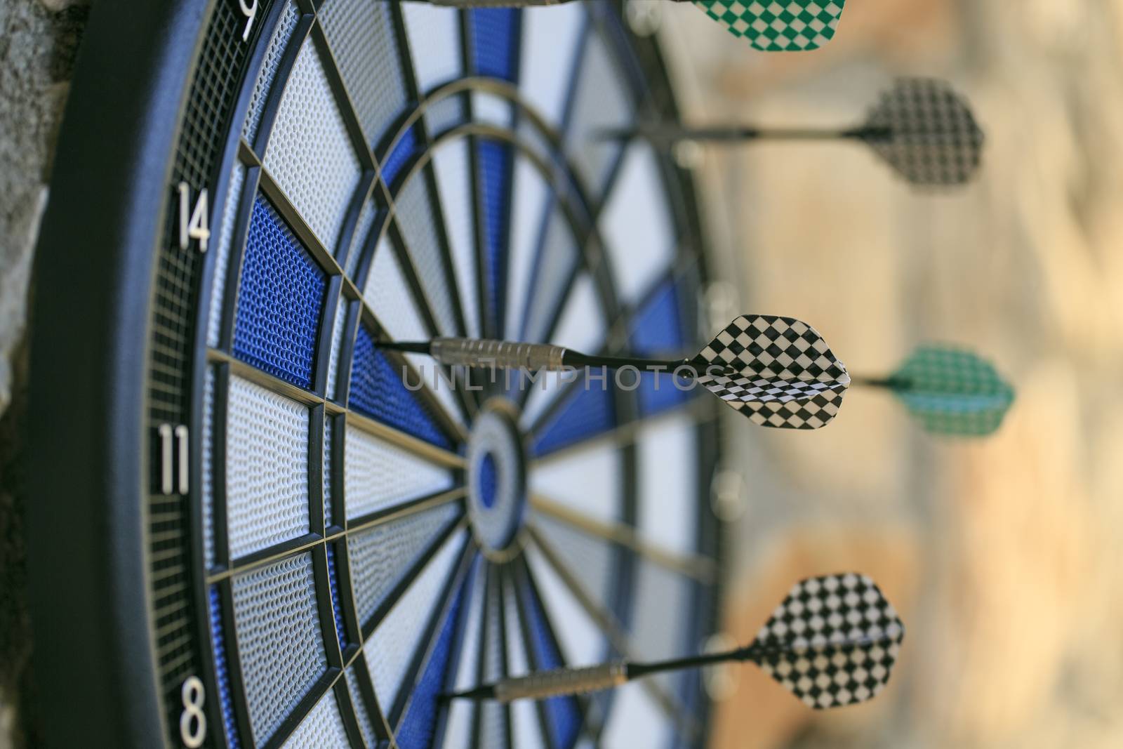 Bullseye on a wall with some darts