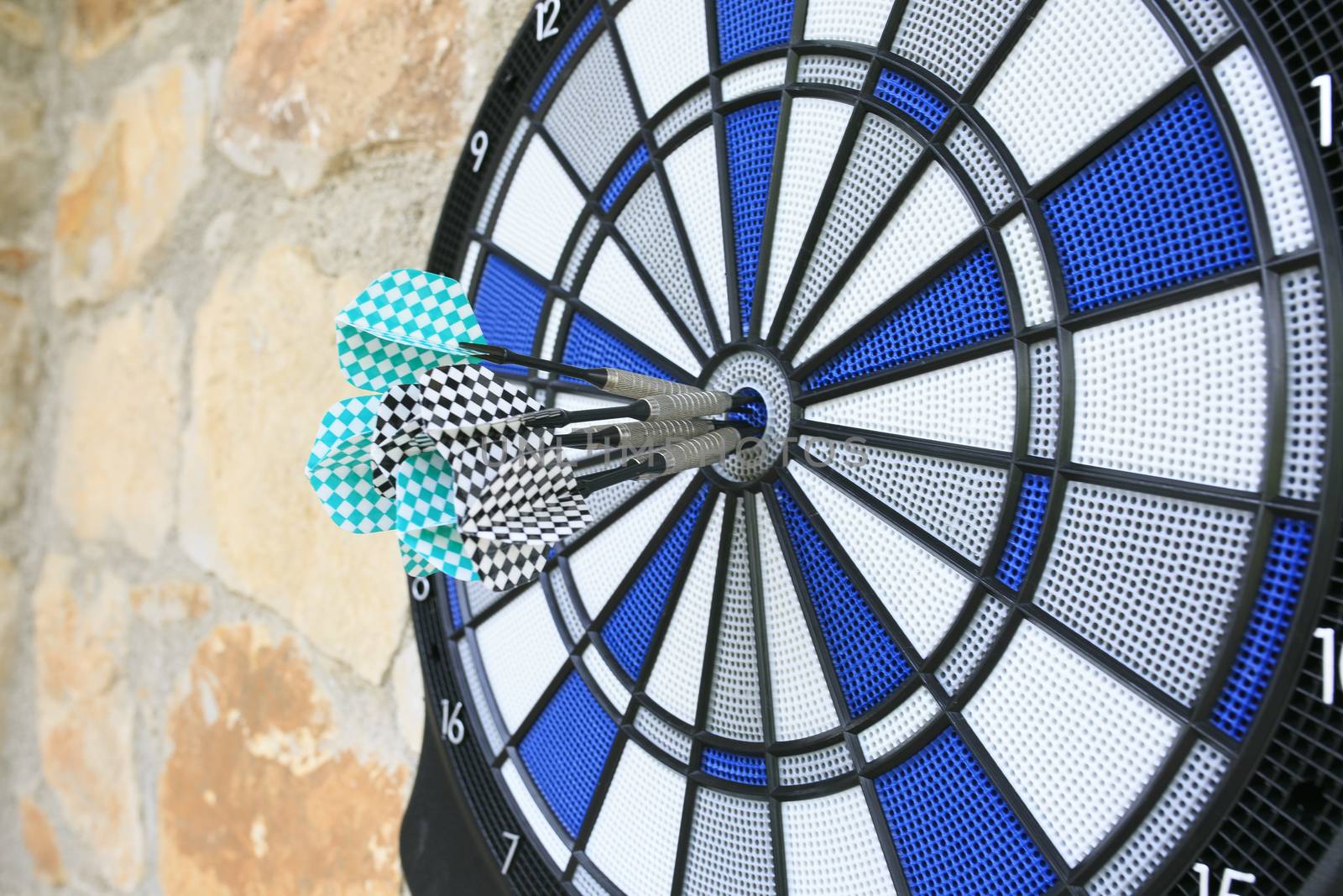 Bullseye on a wall with some darts