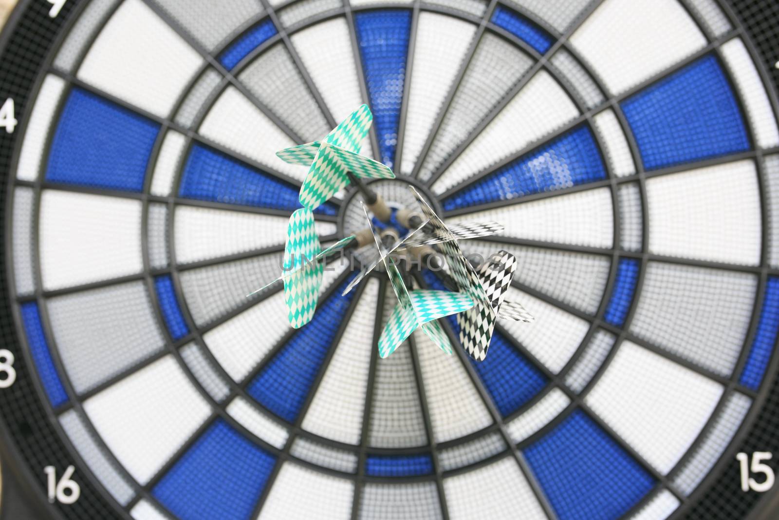 Bullseye on a wall with some darts by nachrc2001