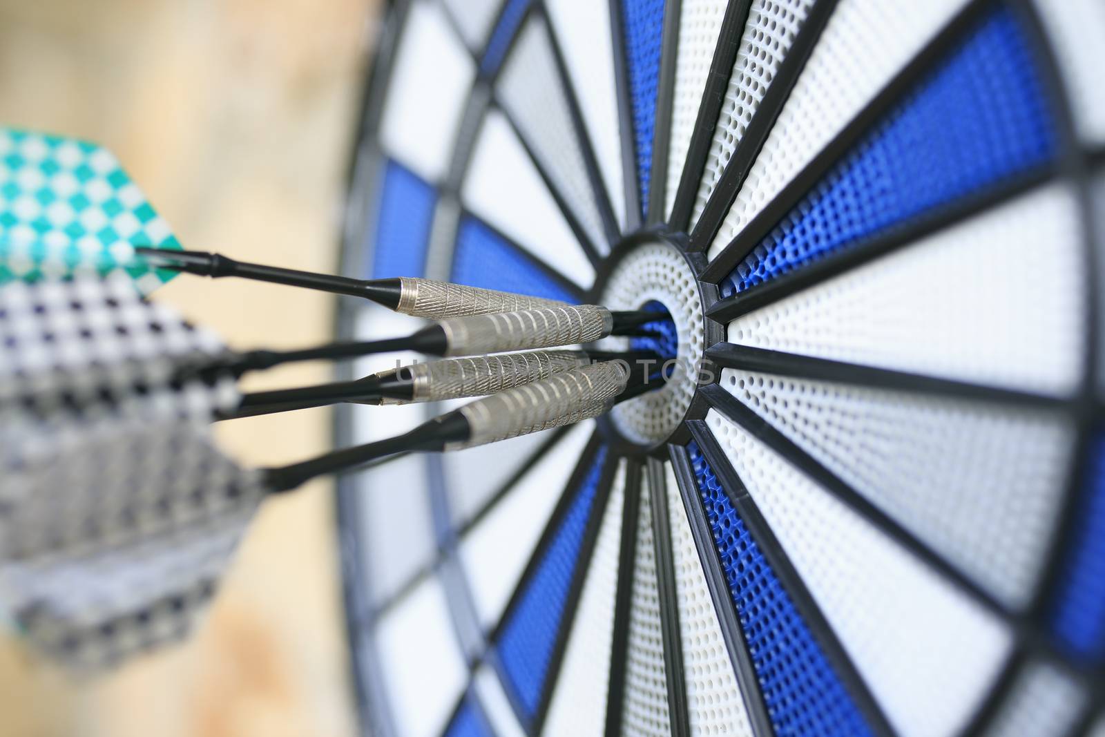 Bullseye on a wall with some darts by nachrc2001