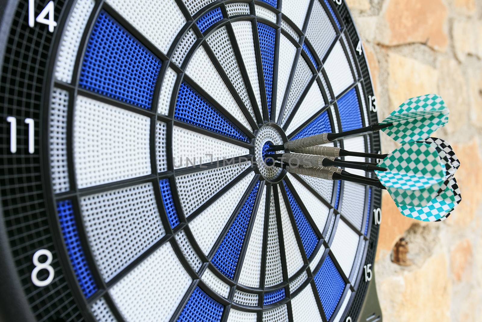 Bullseye on a wall with some darts by nachrc2001