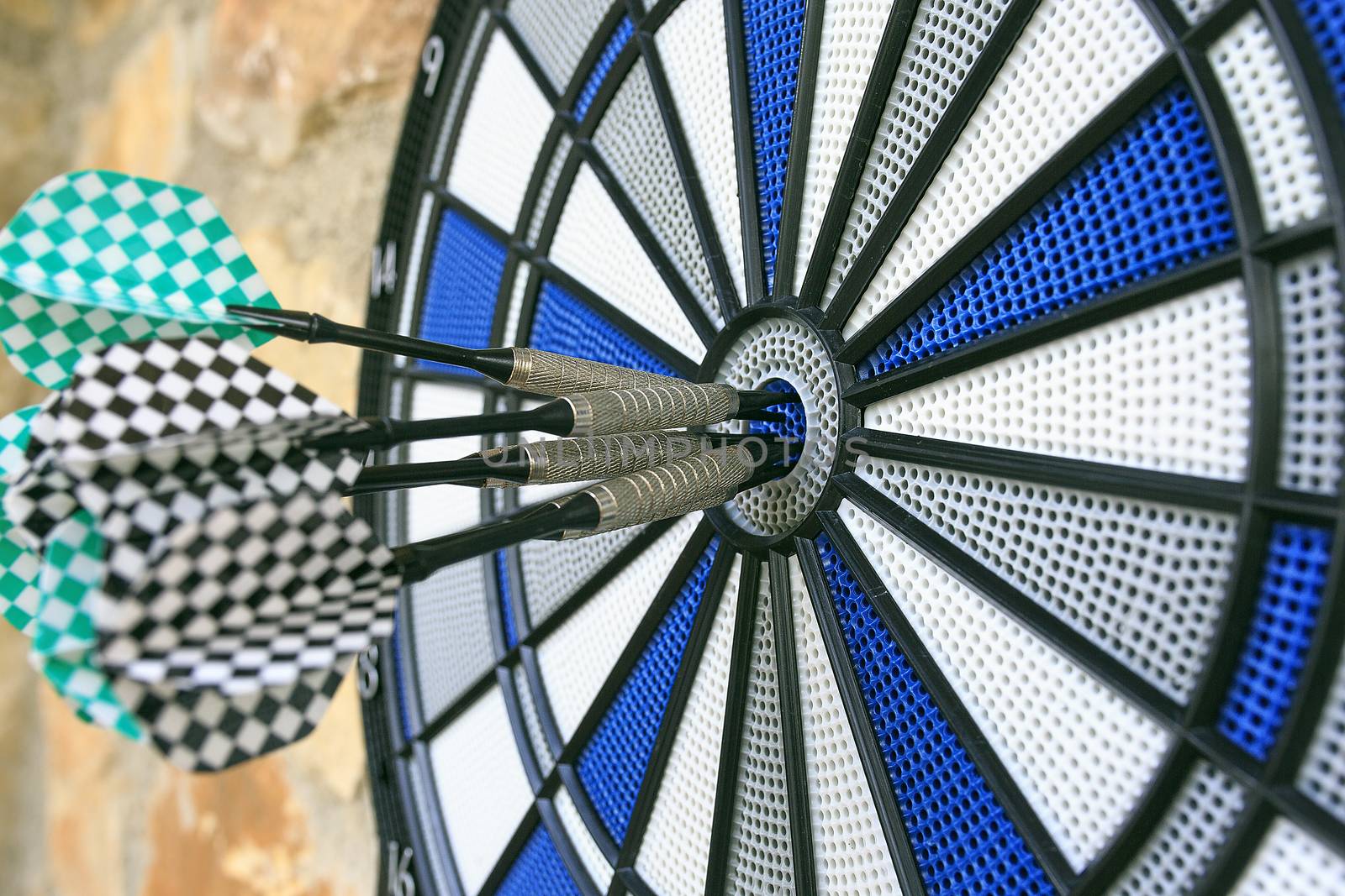 Bullseye on a wall with some darts by nachrc2001