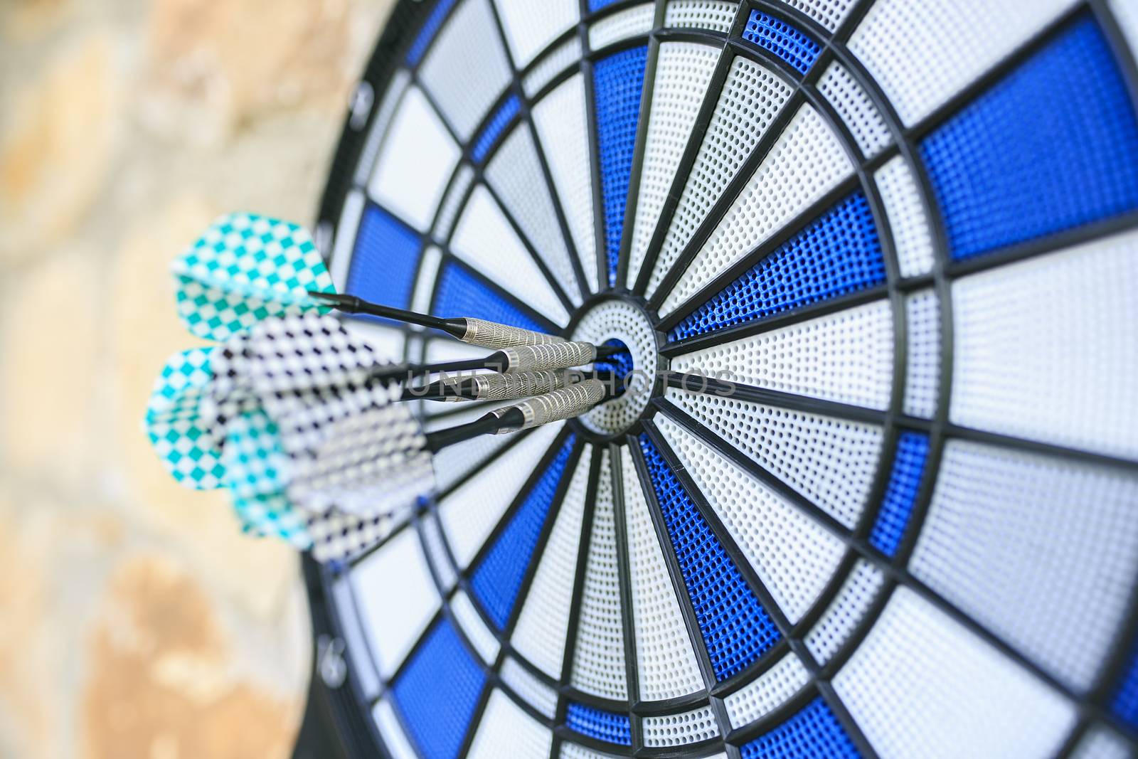 Bullseye on a wall with some darts