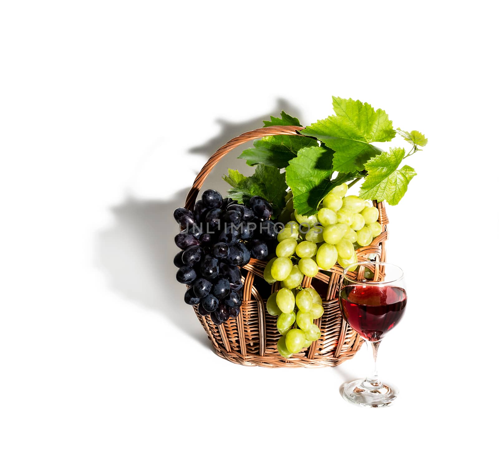Grapes, red wine and vine isolated on white