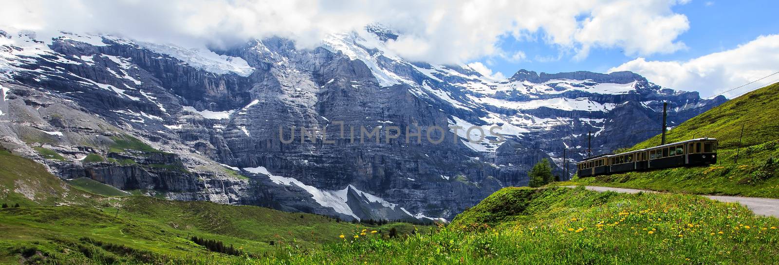 Majestic panoramic view of scenery along a swiss railways train, connecting Kleine Scheidegg to Wengernalp stations, Switzerland.