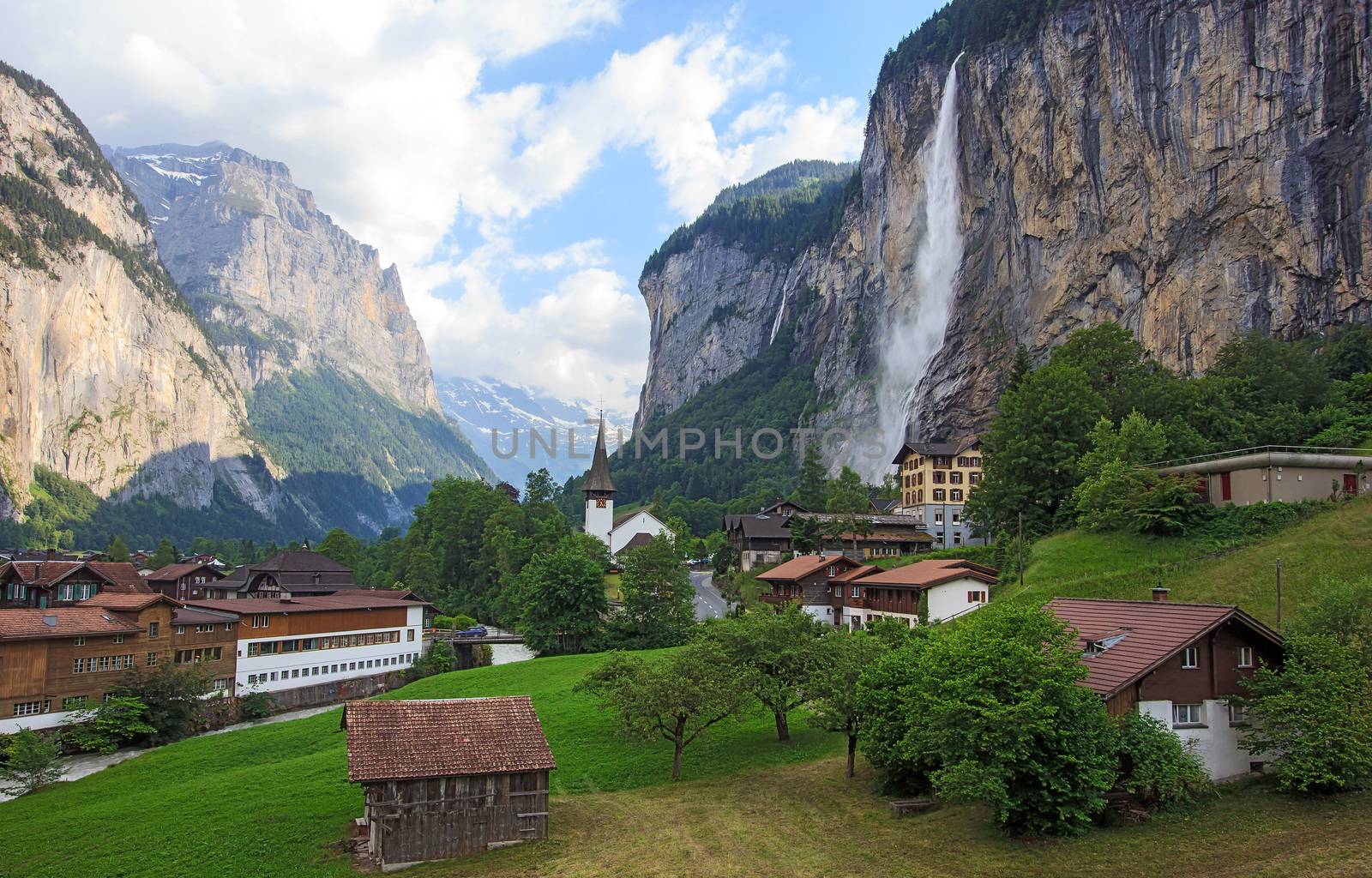 Beautiful Staubbachfall waterfall flowing down the picturesque Lauterbrunnen valley and village in Bern canton, Switzerland, Europe