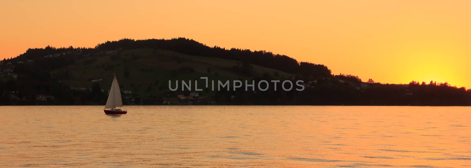 Sailing yacht at sunset on the beautiful Lucerne lake, Switzerla by victorflowerfly