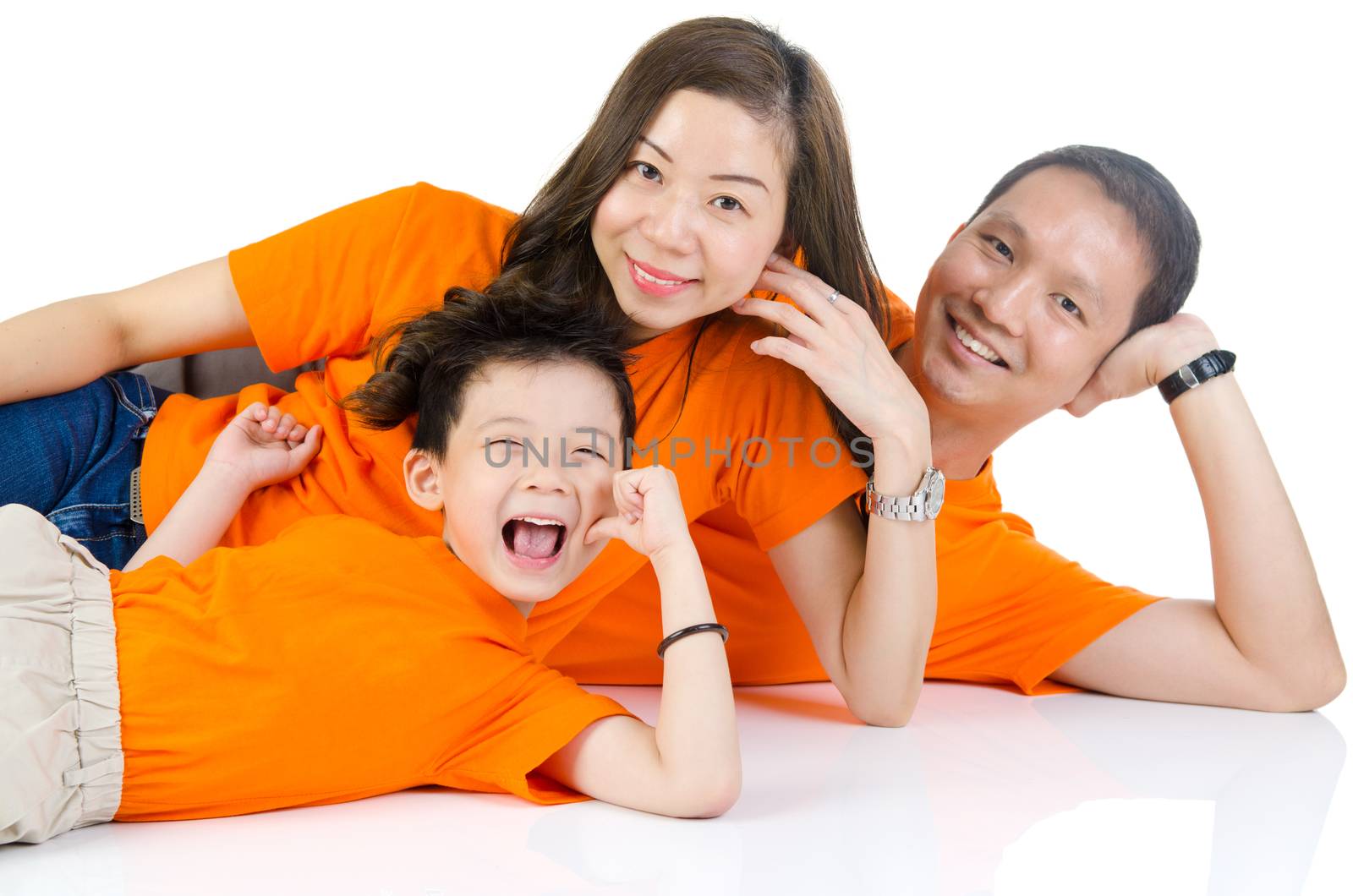 Asian family lying on the floor and smiling,isolated on white background