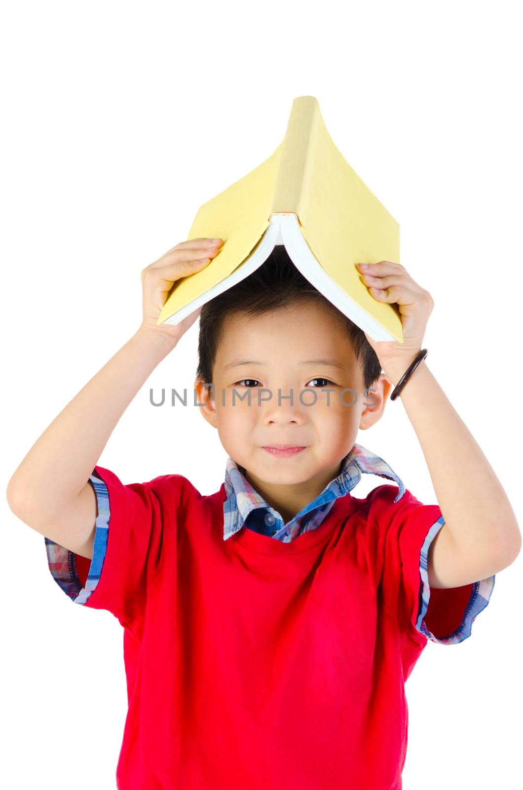 cute kid or boy holding book over head, isolated over white background