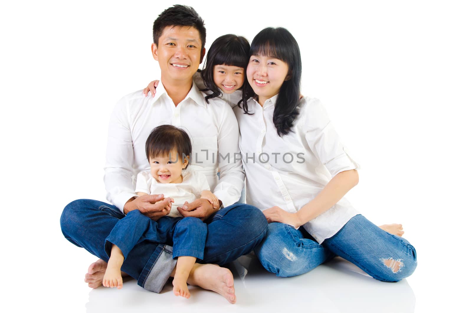 Portrait of a happy asian family in the studio