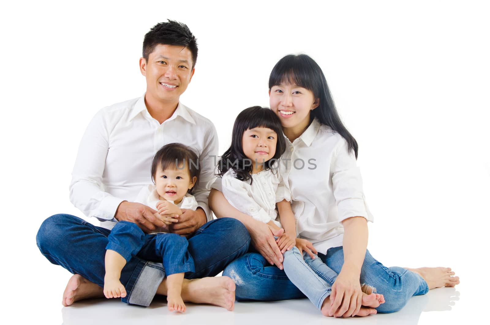 Portrait of a happy asian family in the studio