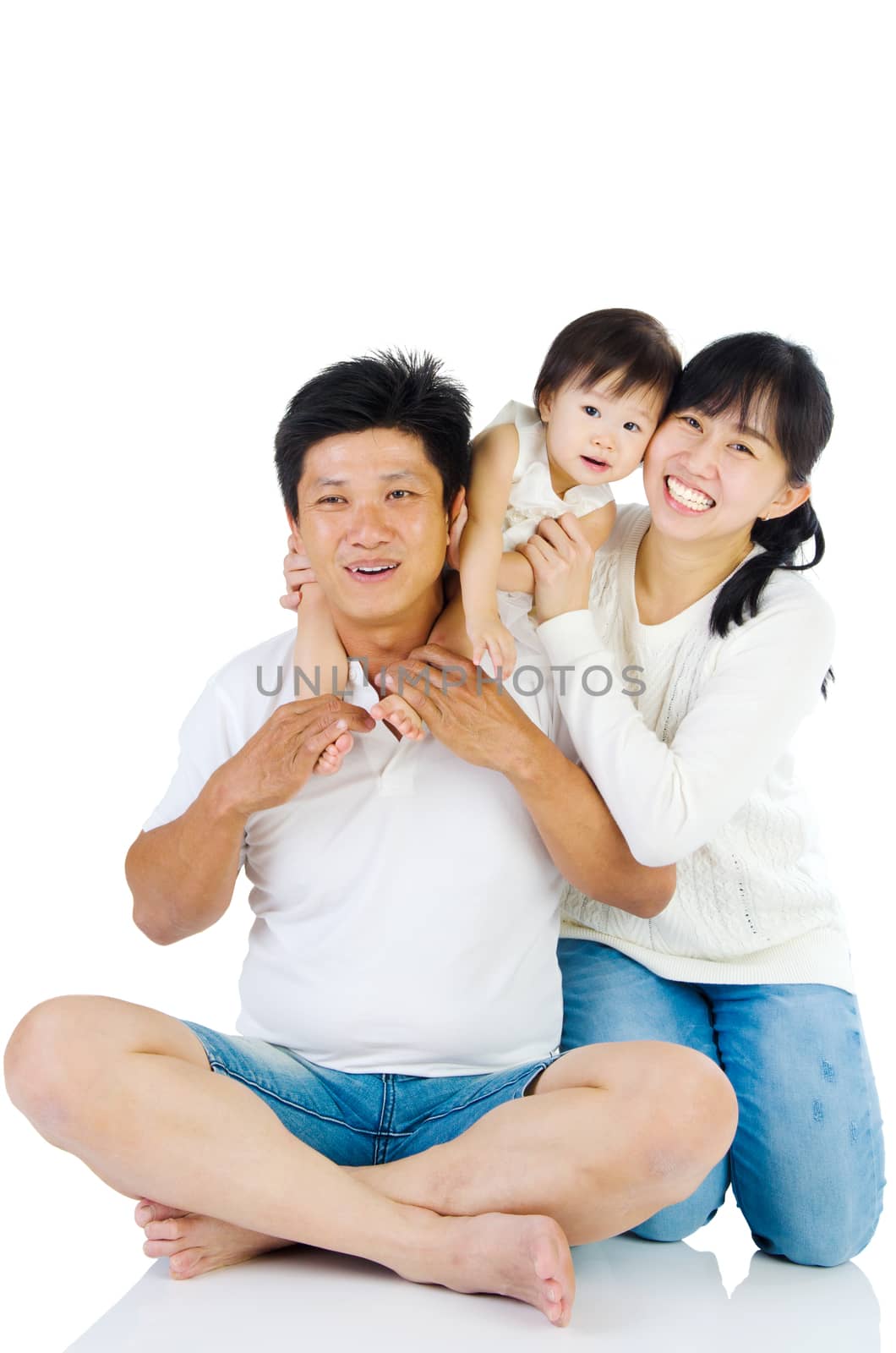 Portrait of a happy asian family in the studio