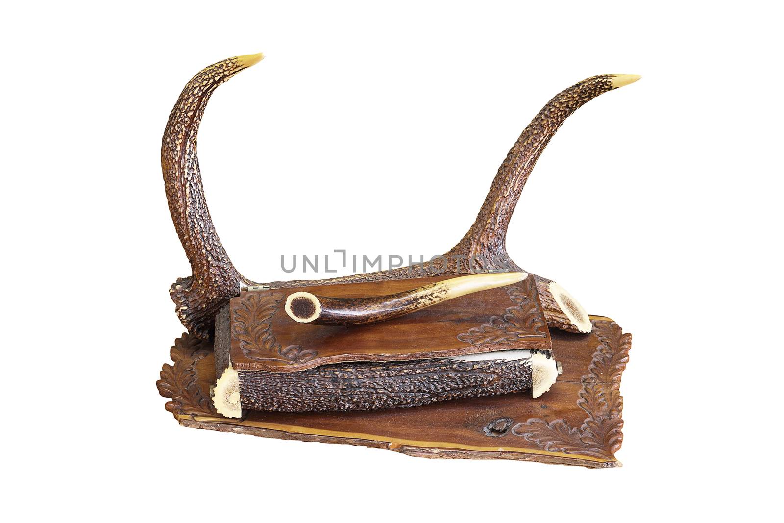 ancient piece of furniture with hunting motifs, isolation of handmade drawer over white background; it is made from wood and red deer pieces of antlers ( Cervus elaphus )