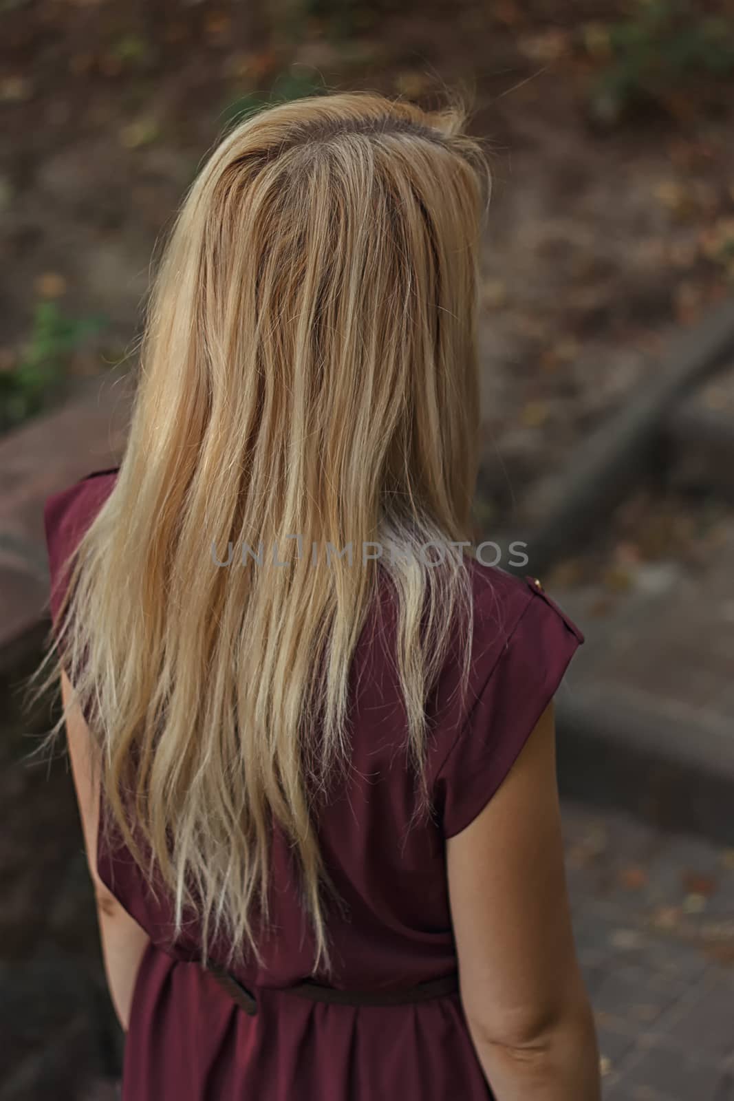 Rear view of young woman going up the stairs in the park