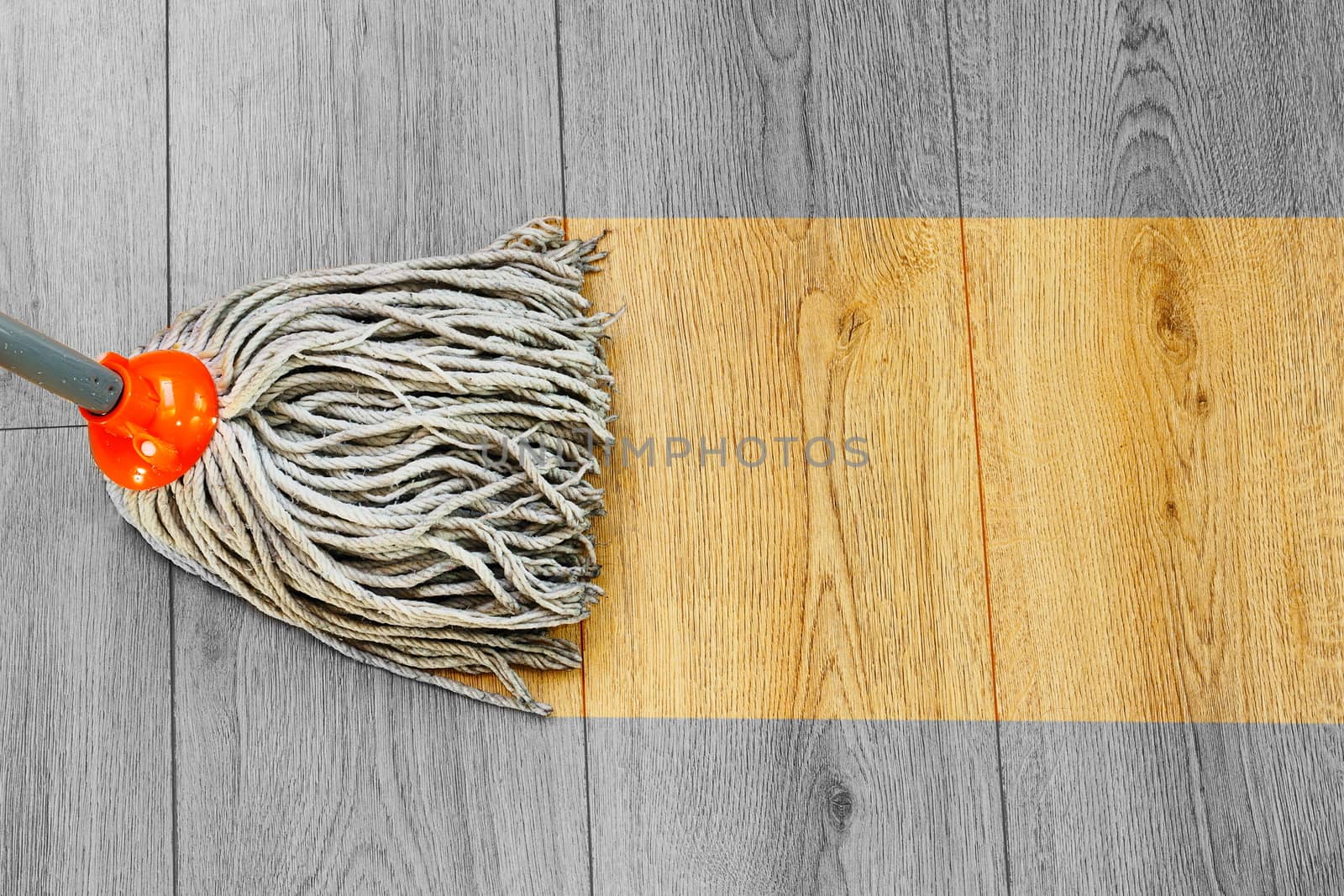 washing dust on wooden floor with mop by taviphoto