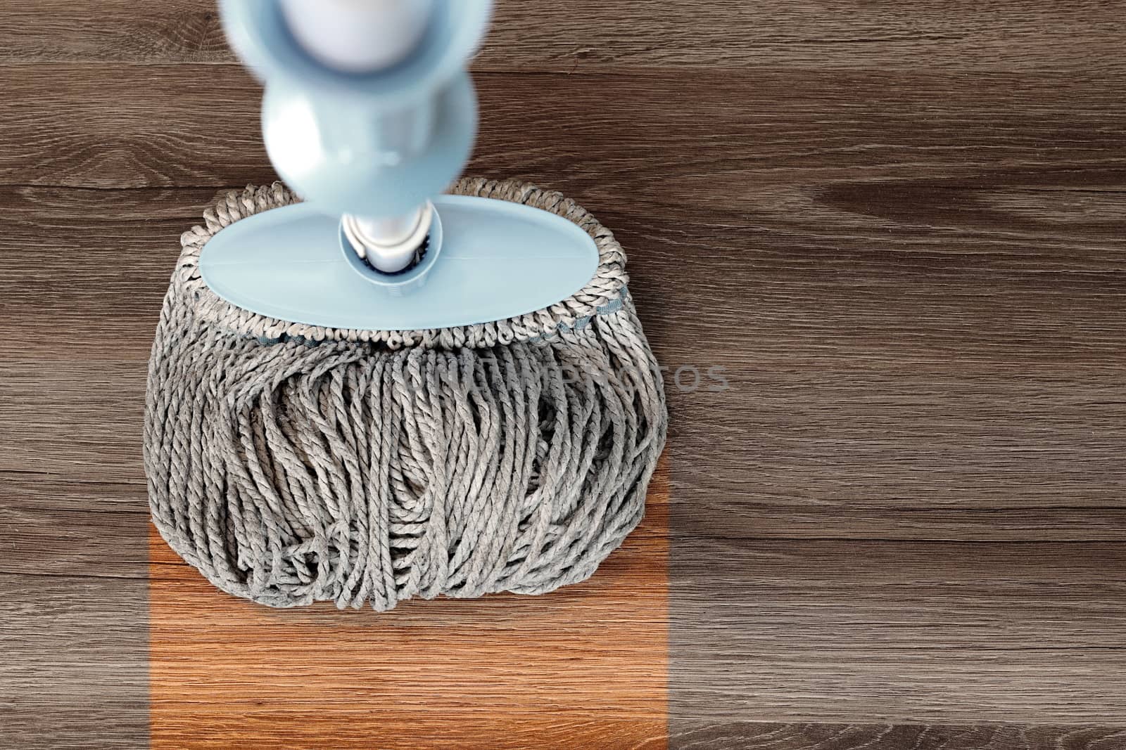 washing dirty wood floor with big mop