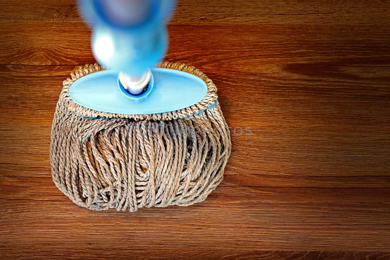 wooden parquet cleaned with a mop by taviphoto