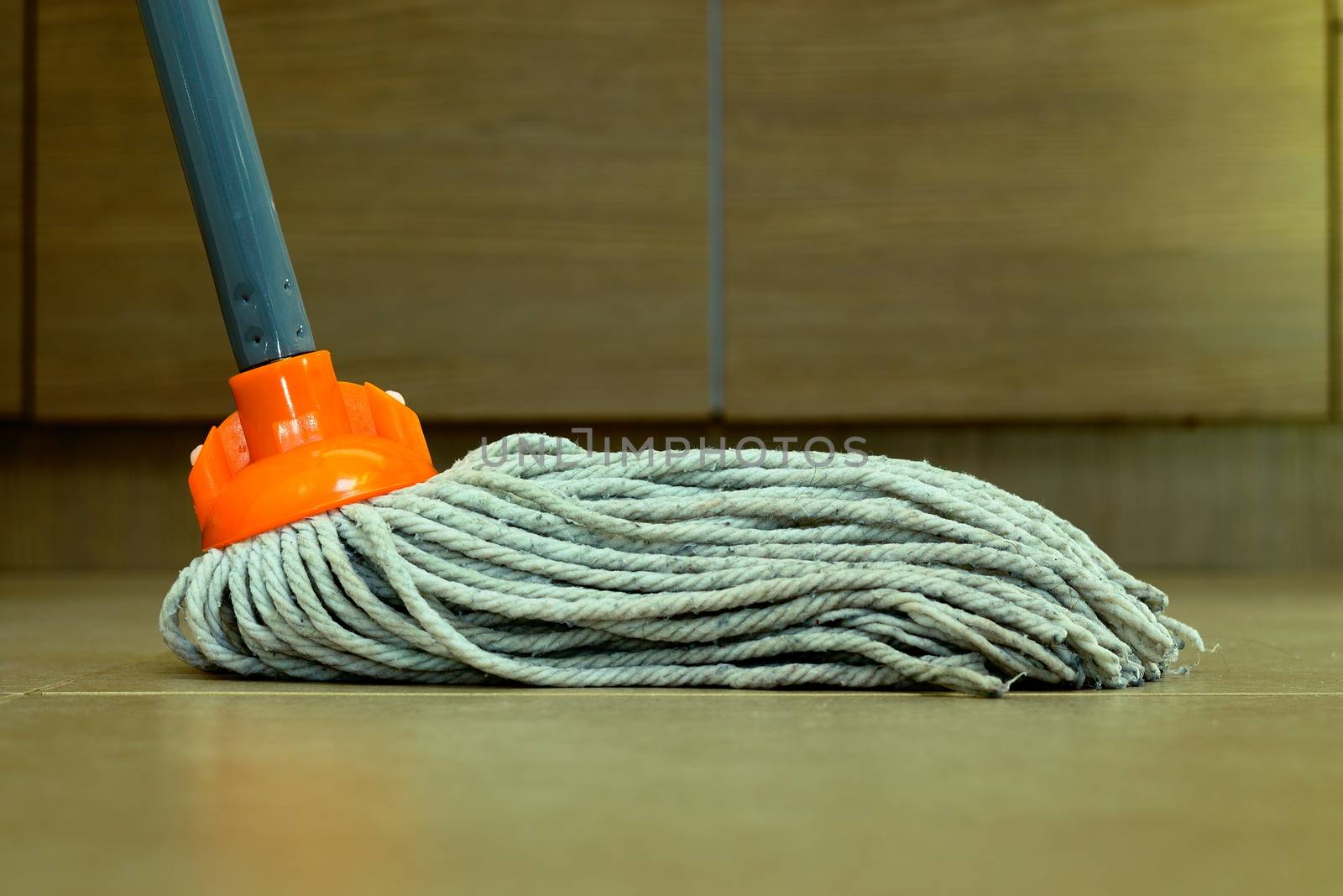 closeup of cleaning the ceramic floor with a mop